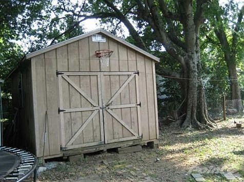 A wonderful large storage shed with room for all of your yard tools.