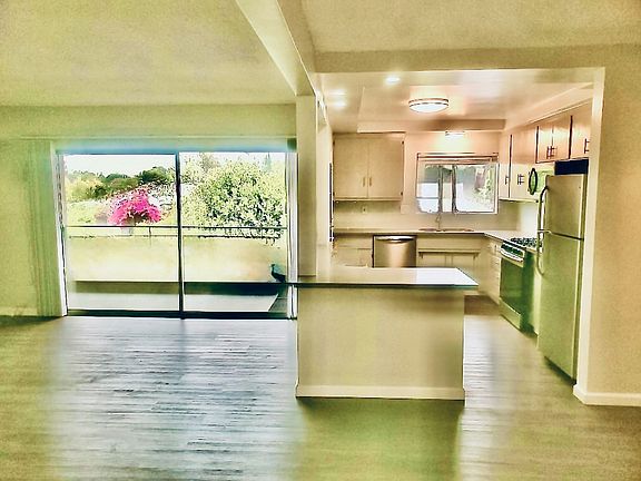 Spacious Living, opens onto private balcony with view of mountains. Gorgeous, huge gourmet kitchen with premium appliances.