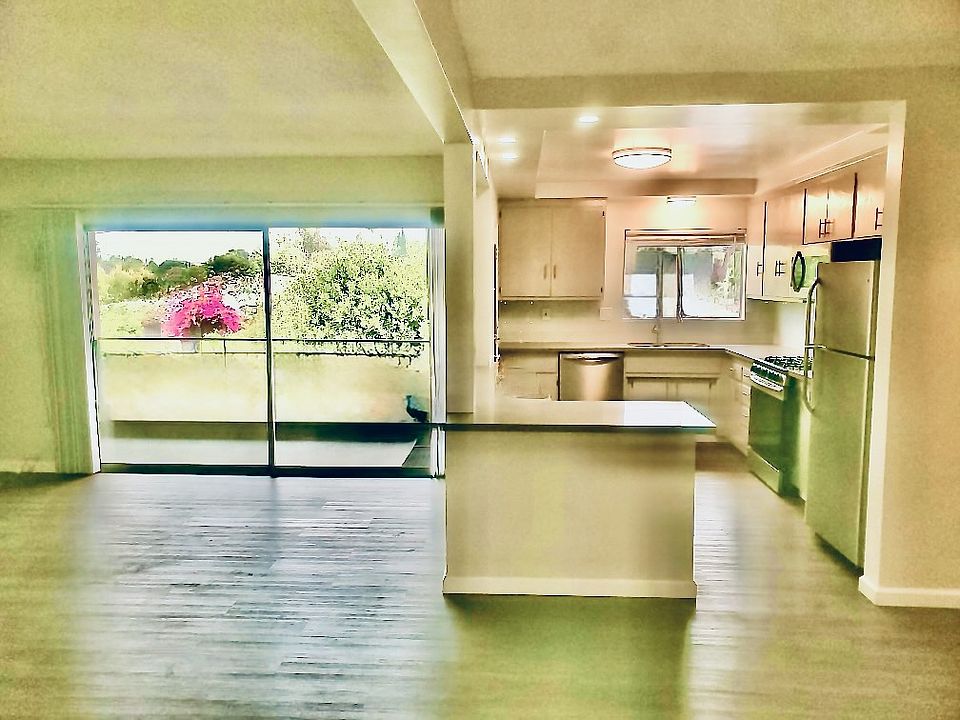 Spacious Living, opens onto private balcony with view of mountains. Gorgeous, huge gourmet kitchen with premium appliances.