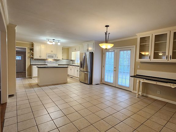 Eat-in kitchen with built-in buffet and French doors to the back patio