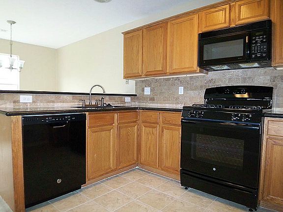 Kitchen boast new dishwasher, gas range and tile.