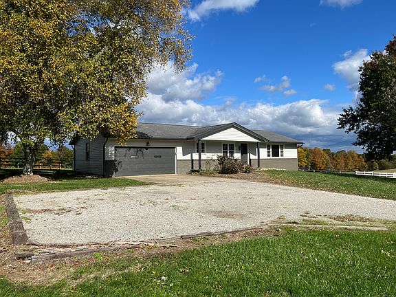 Gravel driveway has extra space for parking and turnaround