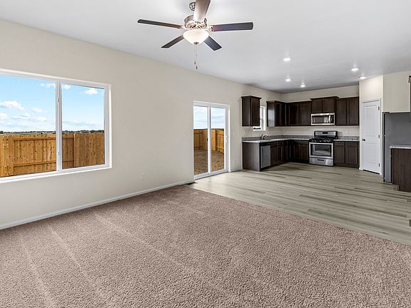 Open-concept layout with a spacious family room, dining area, and upgraded kitchen.