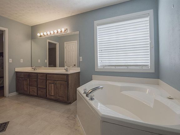 Master bath with separate shower and corner garden