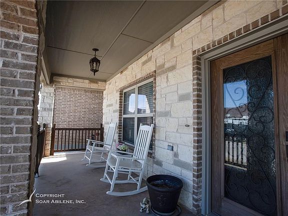 Front door has beautiful wrought iron details.