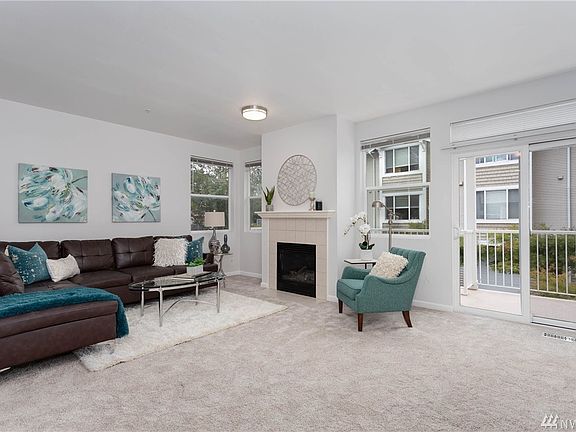 Very spacious living room with tons of natural light, new carpet, new paint, new baseboards, a gas burning fireplace, deck, kitchen and dining room all within steps. 