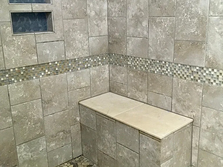 Bathroom in master bedroom large walk-in fully tiled shower with seat.