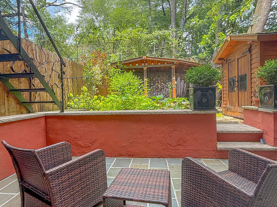 Entertain or unwind on the flagstone patio in your secluded garden retreat.