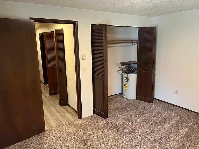 2nd bedroom view towards main hall. Fits queen sized bed. Very roomy space. Large closet. More closets in hallway.