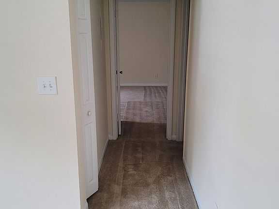 Hallway. Small door on left is a linen closet. Door on the right is the bathroom.