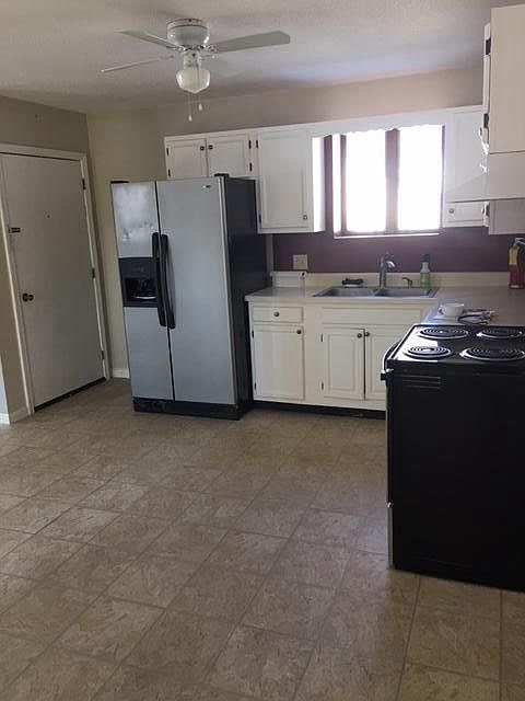 View of kitchen from private entrance. Stainless steel fridge was replace with a black one.