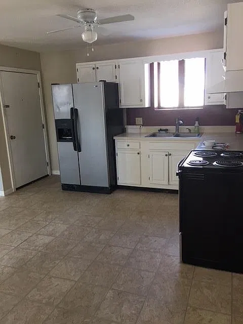 View of kitchen from private entrance. Stainless steel fridge was replace with a black one.