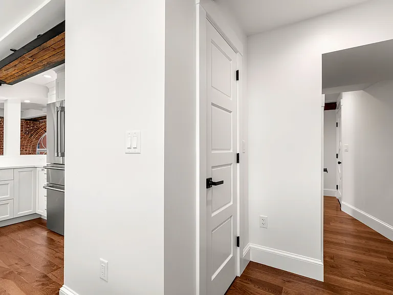 Separate hall from entry door directly to kitchen. Also showing very large pantry closet