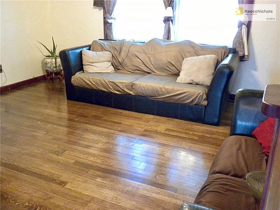 Living Room with NEW hardwood floor that runs into Dining area.