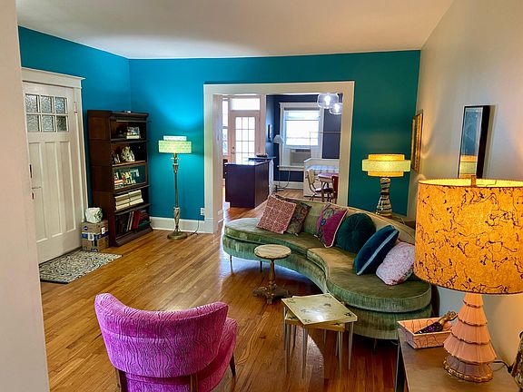 Living room looking south into dining area. Front entry door to left. Back entry door in background.