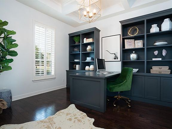 Private study with double French doors, hardwood floors, Plantation shutters, and coffered ceiling accented with crown moldings. Elegant yet functional built ins recently added in 2018 !