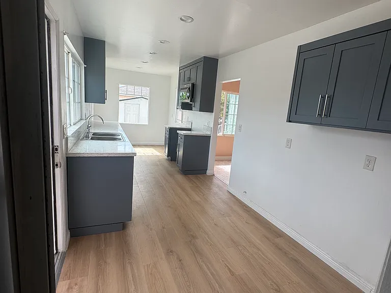 Kitchen and laundry room. Laundry hookups are on the far right where there is cupboards above for any laundry items