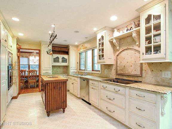 Beautiful Chefs kitchen with granite counters and walls, custom cabinets with tons of counter space.