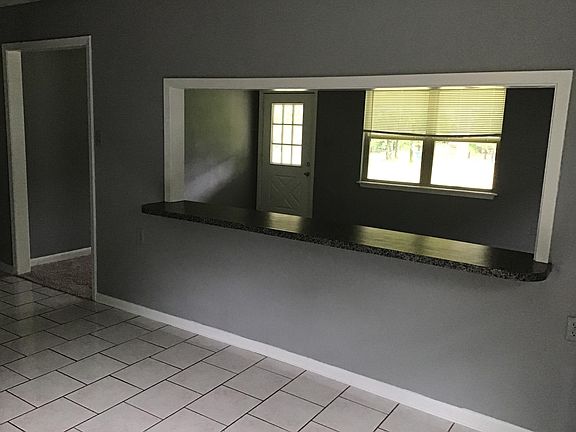 View from dining area into living room and front yard.