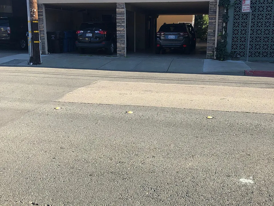 You walk through the carport to the building in the back.