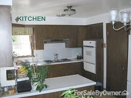 large kitchen with two exhaust fans