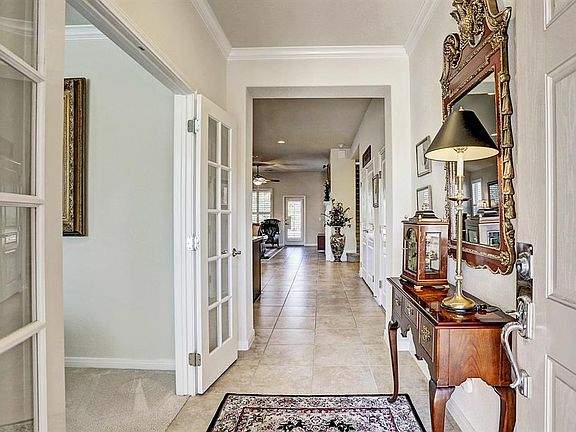 As you enter the tiled entry with crown molding and neutral colors you will recognize the pride of ownership.