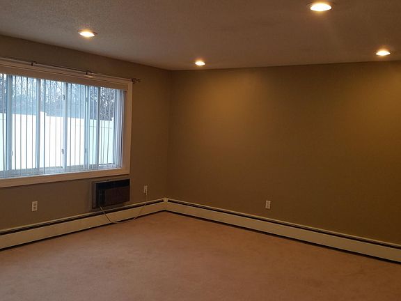 Living room with window overlooking patio