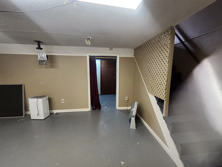 view into laundry/utility area from bonus room/flex space