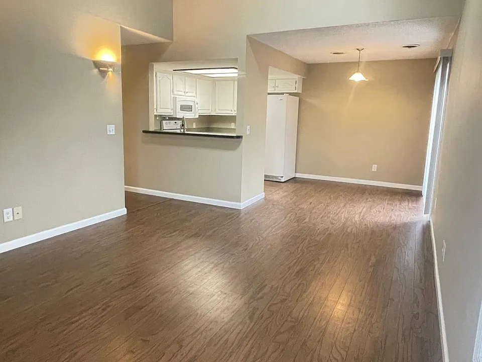 Spacious Living Room with Hardwood Plank floors, rough-sawed Cedar-Vaulted Ceiling, and Skylight