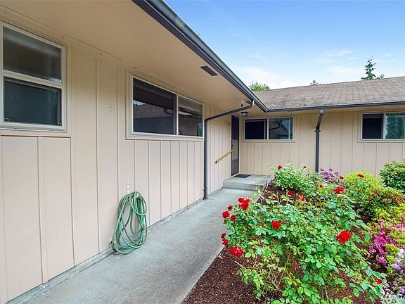 Updated windows, newer exterior paint & nice walkways welcome you to the front of the home with a lovely rose garden & lush landscape