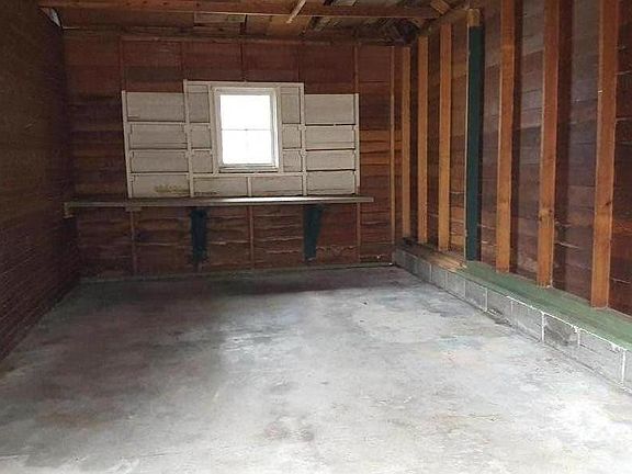 Interior of garage - bench and shelving at end for workshop / tools / projects