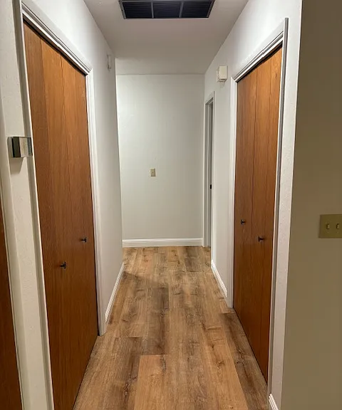 Hallway with three closets to bedrooms.
