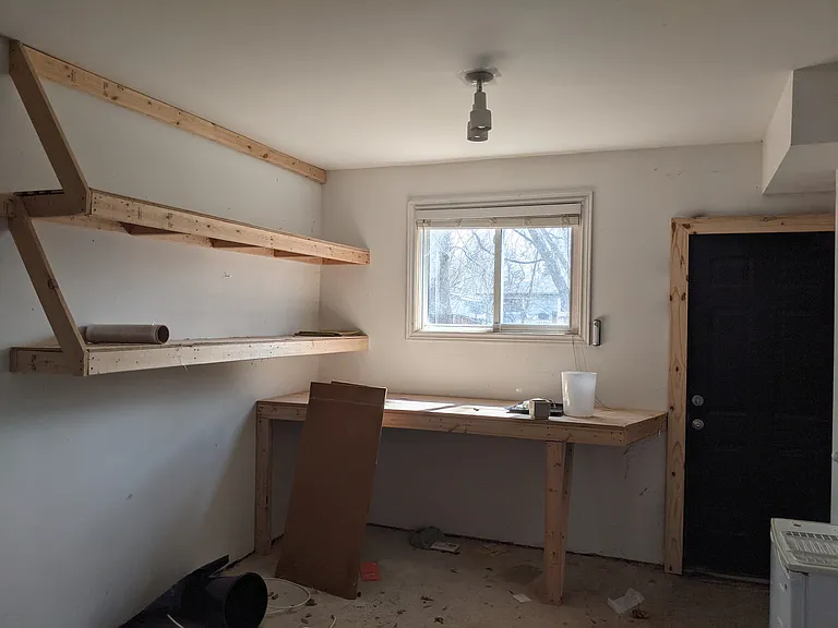 Garage has a small workspace.