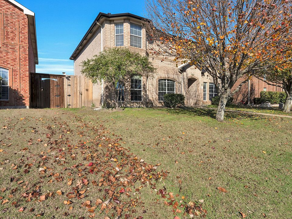 This home boasts a large and beautiful front yard, perfect for kids to play and families to enjoy. The yard features two mature trees, offering plenty of shade and a lovely natural setting. Flower beds add vibrant color throughout the seasons. Situated on