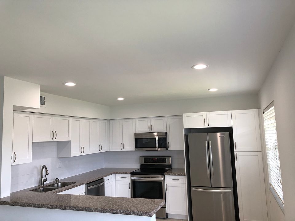 Open big kitchen with a lots of cabinets including a pantry.