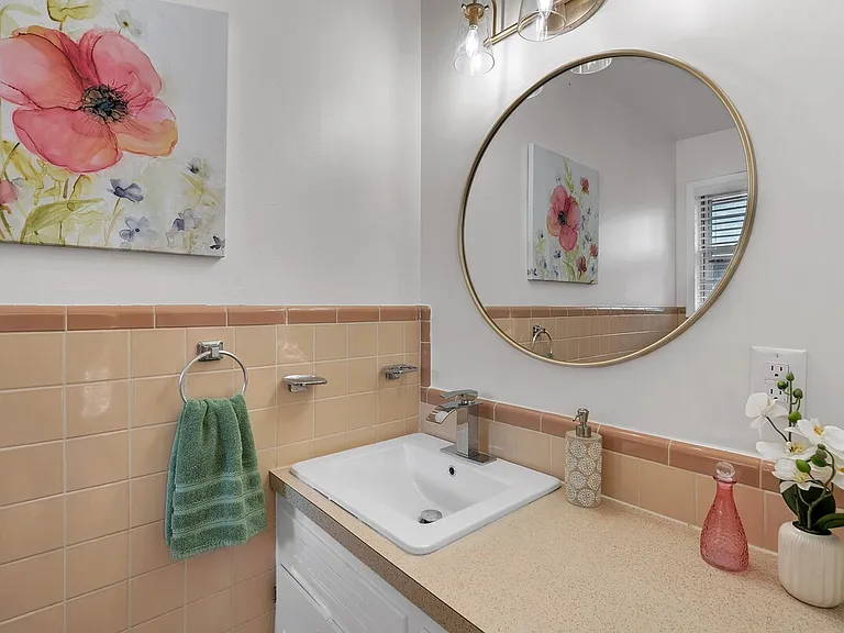Charming vintage-style bath with blush tile and walk-in shower.
