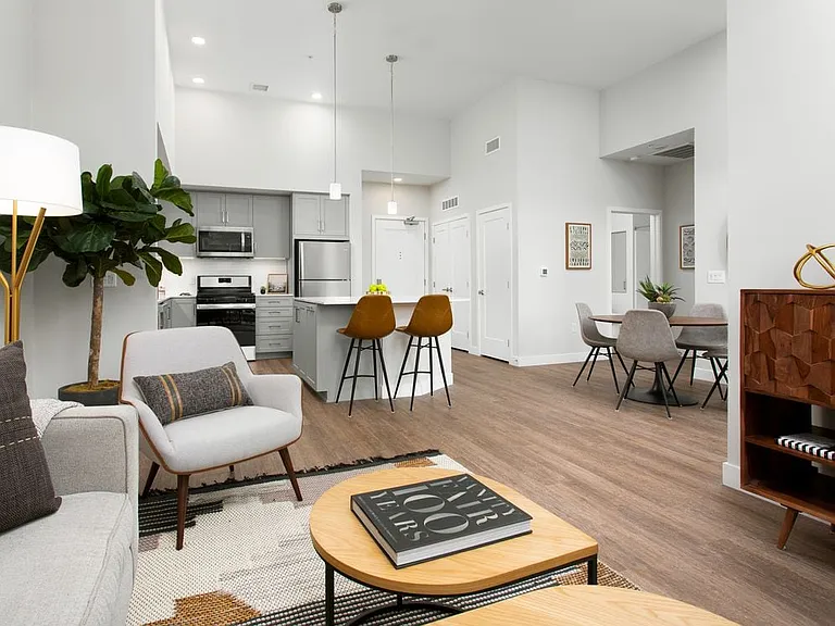 Apartments with hard surface flooring in kitchen, living, and dining areas