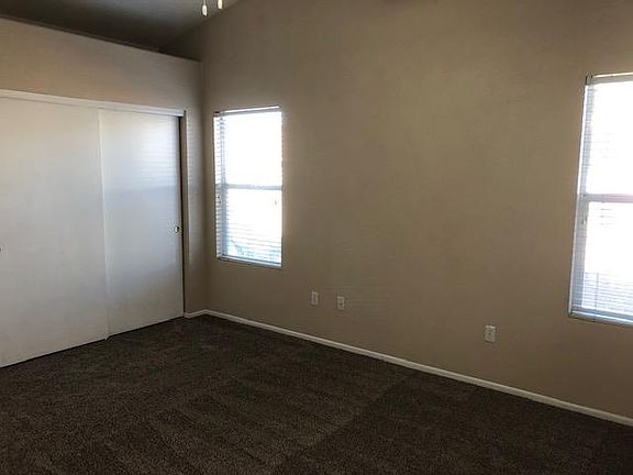 Master with vaulted ceilings and two closets.