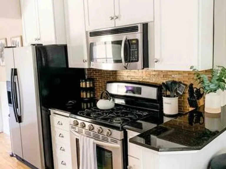 Four burner stove with above mounted microwave.