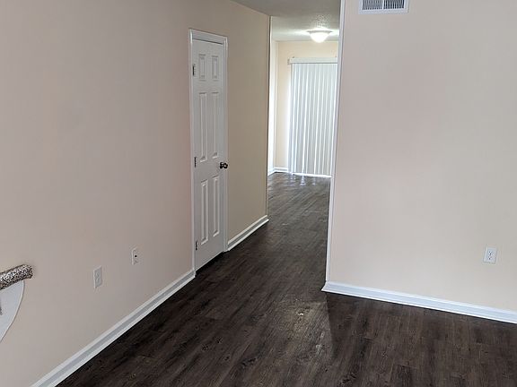 Hallway to powder room, kitchen & dining area