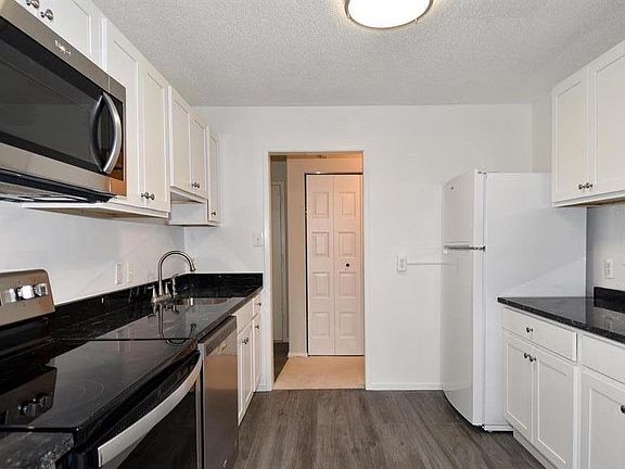 Plenty of cabinets on both sides of the kitchen