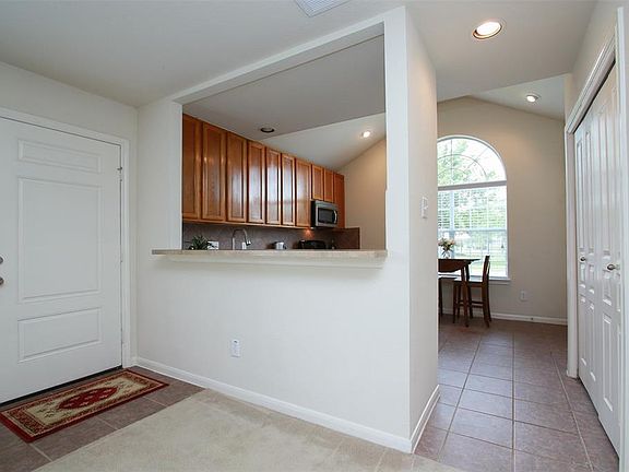 Roomy kitchen with plenty of cabinet space and tile floor.
