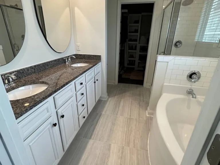 Primary bathroom with tub, shower, and large closet (great water pressure!)