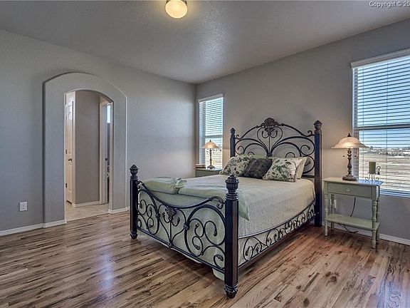 The large master bedroom also has the beautiful wood-flooring and large windows.