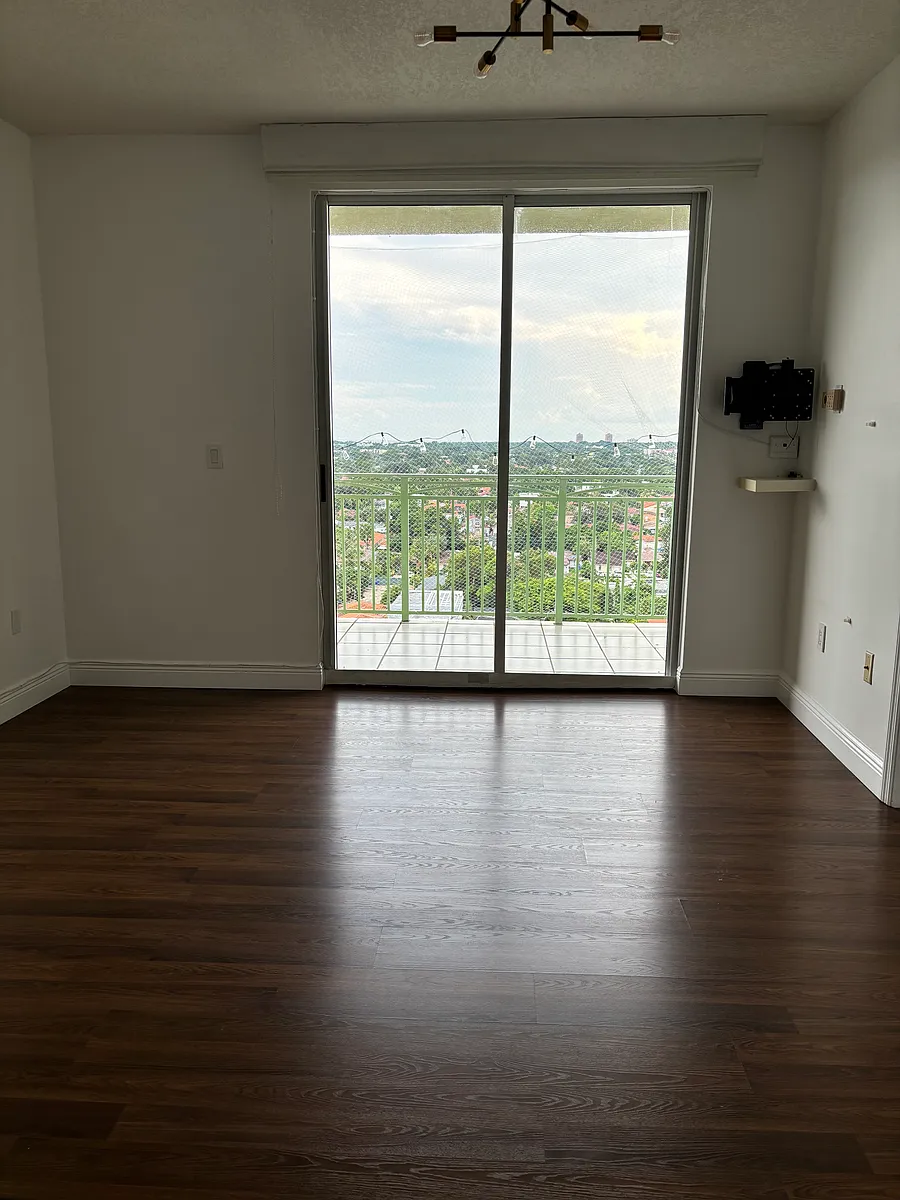Living room with access to balcony and open view to Coconut Grove/ Key Biscayne. - 3500 Coral Way #1509