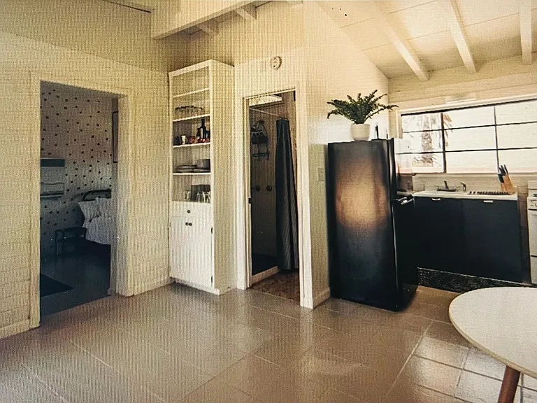 Kitchen with dining room in corner. Built in bookcase. Step down to living room.
