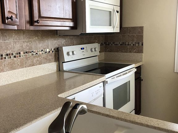 Raised Wood Panel Cabinets, Corian Counter tops, Tiled kitch