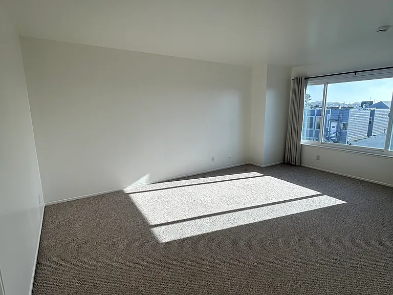 This bright sunny living room faces west and is situated in the back of the building. This room is spacious enough to be a combo dining and living room.