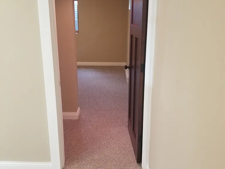 Additional storage / hanging clothes rod under the stairs.