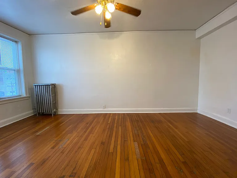 The generously sized bedroom offers plenty of room for larger furniture and includes a walk-in closet that makes excellent use of vertical storage space.